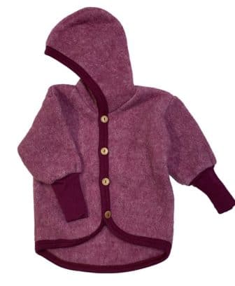 Myk og varm jakke fra Cosilana med hette og treknapper i en stødig økologisk ull/bomulls fleece kvalitet. Denne ullkvaliteten kombinerer styrkene fra både ull og bomull. Kombinasjonen gjør ullfleecen mer slitesterkt, vindtett og plagget får bedre isolasjonsevne. Det er gode ribbekanter på armene som kan brettes opp/ned som gjør at det er litt å vokse i.